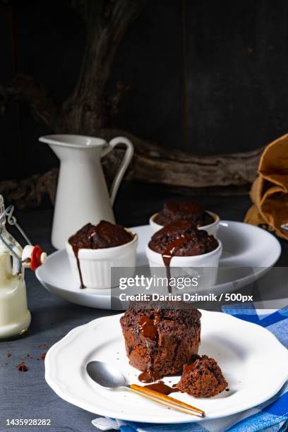 delicious chocolate muffins with chocolate chips - chocolate souffle stock pictures, royalty-free photos & images