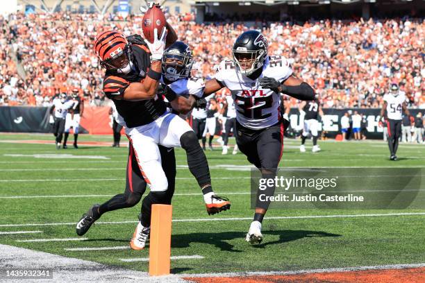 Ja'Marr Chase of the Cincinnati Bengals reaches for a touchdown after making a catch while defended by Cornell Armstrong and Jaylinn Hawkins of the...