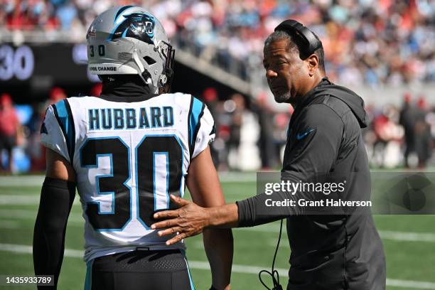 Head coach Steve Wilks talks to Chuba Hubbard of the Carolina Panthers on the sidelines in the second quarter at Bank of America Stadium on October...