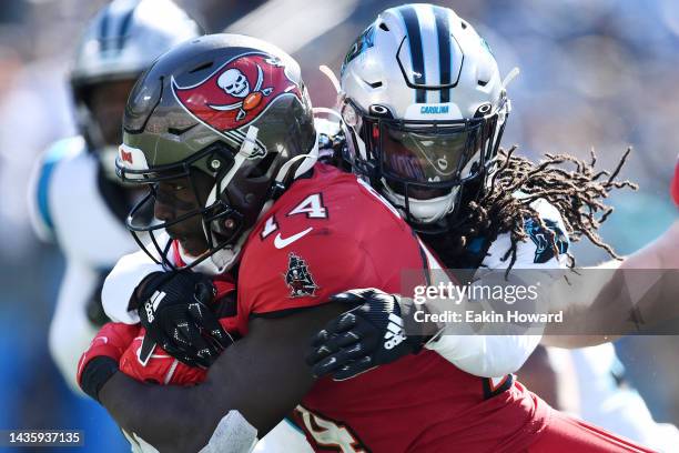 Madre Harper of the Carolina Panthers tackles Chris Godwin of the Tampa Bay Buccaneers in the third quarter at Bank of America Stadium on October 23,...