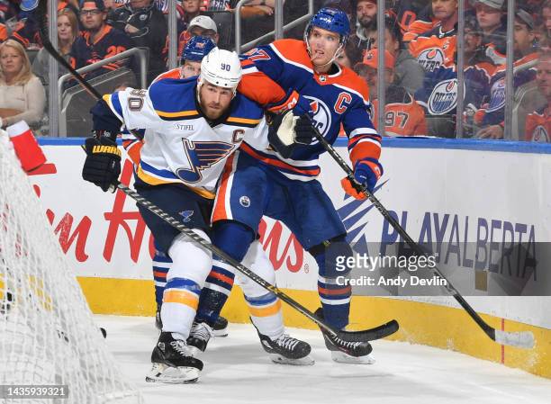 Connor McDavid of the Edmonton Oilers battles for position with Ryan O'Reilly of the St. Louis Blues during the game on October 22, 2022 at Rogers...