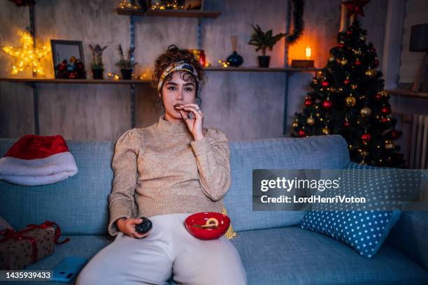 woman watching tv at home - binge watching stock pictures, royalty-free photos & images