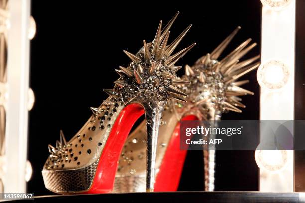 Picture shows a shoe at a preview of an exhibition by French shoe designer Christian Louboutin showcasing 20 years of the famous red-soled shoes at...