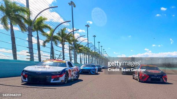 William Byron, driver of the Liberty University Chevrolet, and Christopher Bell, driver of the Rheem - WATTS Toyota, lead the field on a pace lap...