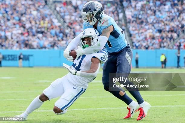 Nyheim Hines of the Indianapolis Colts runs with the ball against Amani Hooker of the Tennessee Titans during the first half at Nissan Stadium on...