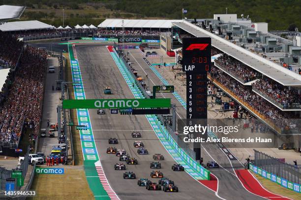 Max Verstappen of the Netherlands driving the Oracle Red Bull Racing RB18 leads Carlos Sainz of Spain driving the Ferrari F1-75 and the rest of the...