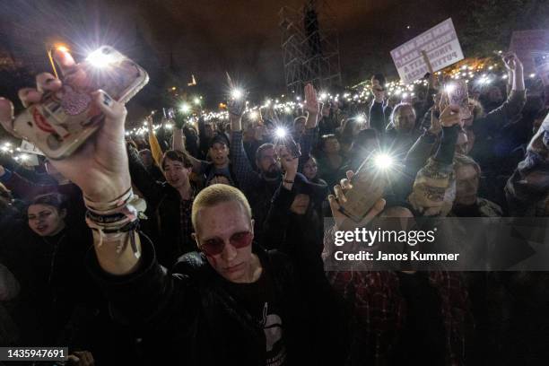 Protestors hold mobile phones during a sympathy march to show their support for teachers on October 23, 2022 in Budapest, Hungary. On October 23...