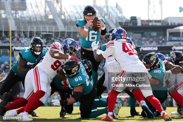 Trevor Lawrence of the Jacksonville Jaguars leaps over the line for a touchdown in the third quarter against the New York Giants at TIAA Bank Field...