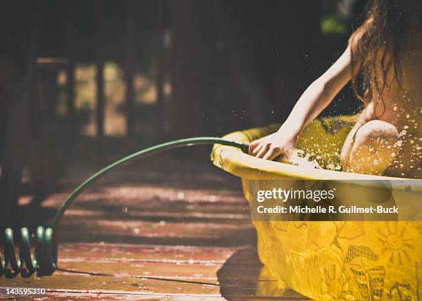 child in plastic pool - washing tub stockfoto's en -beelden