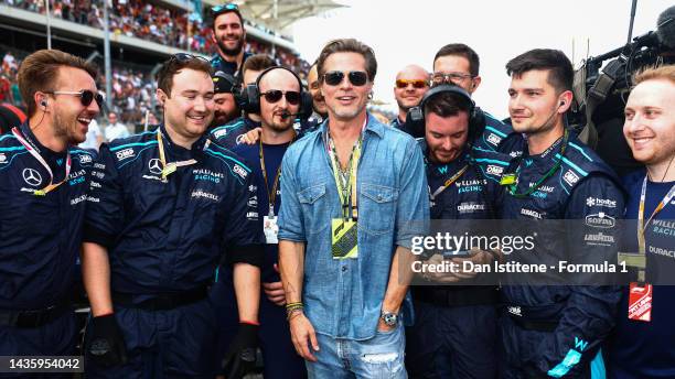 Brad Pitt poses for a photo with the Williams team during the F1 Grand Prix of USA at Circuit of The Americas on October 23, 2022 in Austin, Texas.