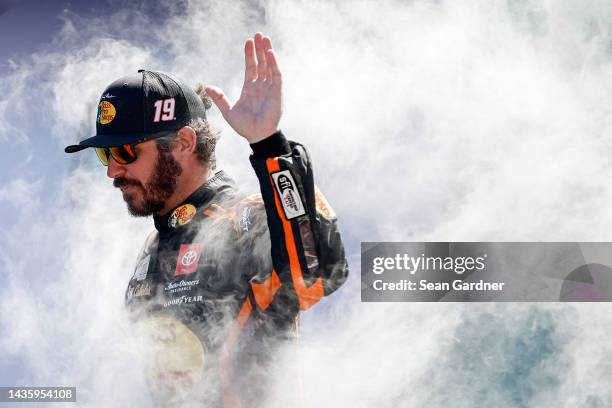 Martin Truex Jr., driver of the Bass Pro Shops Toyota, waves to fans as he walks onstage during driver intros prior to the NASCAR Cup Series Dixie...