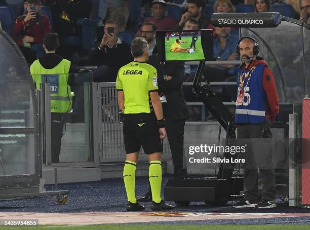 The referee Massimiliano Irrati checks the VAR during the Serie A match between AS Roma and SSC Napoli at Stadio Olimpico on October 23, 2022 in...