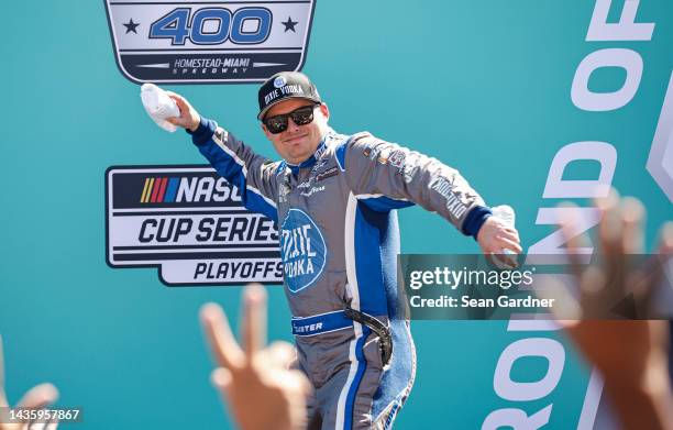 Cole Custer, driver of the Dixie Vodka Ford, throws t-shirts to fans as he walks onstage during driver intros prior to the NASCAR Cup Series Dixie...