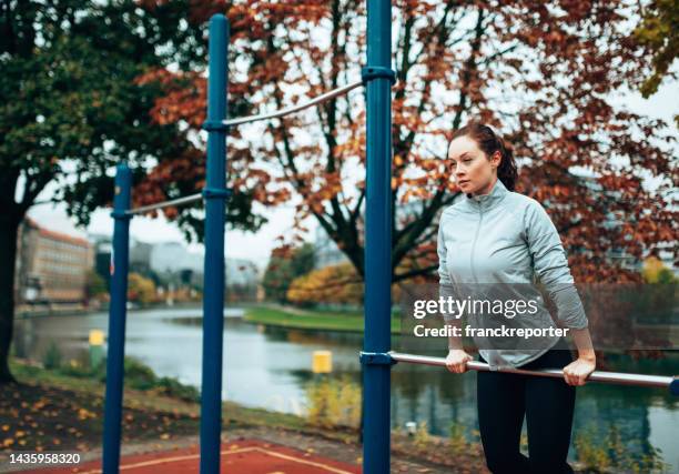 fitness woman doing exercise in autumn in berlin - traction stock pictures, royalty-free photos & images