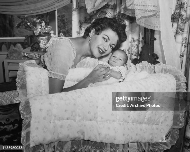 Yvonne De Carlo poses with her baby boy Bruce Ross Morgan, United States, 20th July 1956.