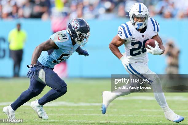 Jonathan Taylor of the Indianapolis Colts runs with the ball against David Long Jr. #51 of the Tennessee Titans during the second half at Nissan...