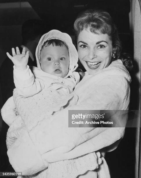 Janet Leigh smiles holding her baby daughter Jamie Lee Curtis in her arms, United States, circa 1959.