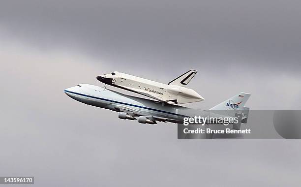 Riding atop a 747 shuttle carrier aircraft, the space shuttle Enterprise flies over New York Harbor on April 27, 2012 in New York City. Enterprise,...