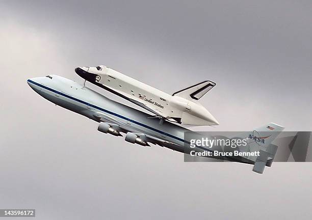 Riding atop a 747 shuttle carrier aircraft, the space shuttle Enterprise flies over New York Harbor on April 27, 2012 in New York City. Enterprise,...