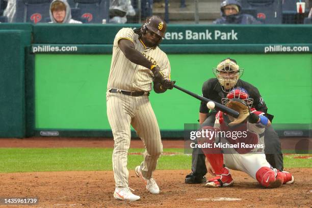 Josh Bell of the San Diego Padres hits an RBI double during the seventh inning against the Philadelphia Phillies in game five of the National League...