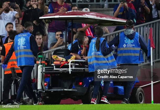 Sergi Roberto of FC Barcelona receives medical treatment while being taken off the pitch in a cart during the LaLiga Santander match between FC...