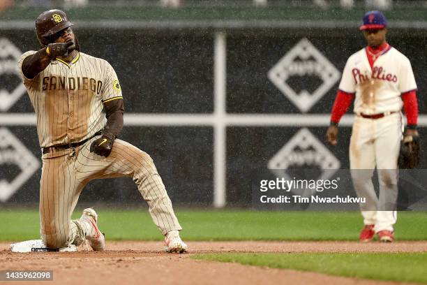 Josh Bell of the San Diego Padres reacts after hitting an RBI double during the seventh inning against the Philadelphia Phillies in game five of the...