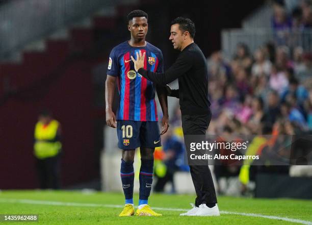 Xavi, Head Coach of FC Barcelona interacts with Ansu Fati during the LaLiga Santander match between FC Barcelona and Athletic Club at Spotify Camp...
