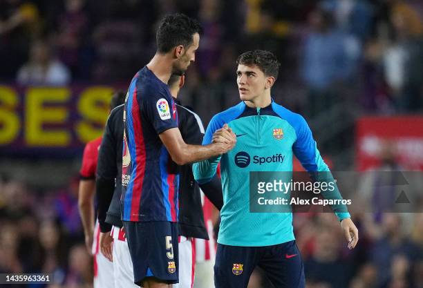 Sergio Busquets of FC Barcelona shakes hands with Gavi following their side's victory in the LaLiga Santander match between FC Barcelona and Athletic...