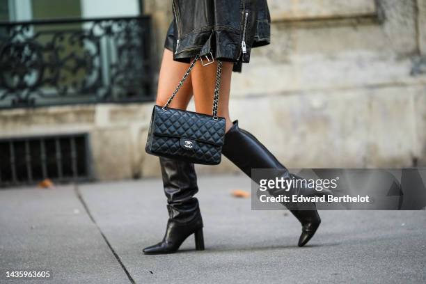 Diane Batoukina wears a black oversized leather jacket from Zara, black leather shorts from LPA, knee-high leather boots from Massimo Dutti, a bag...