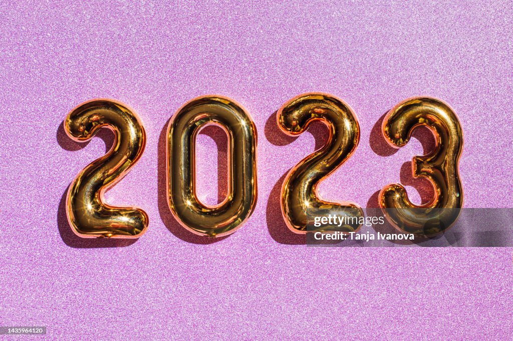 2023 Happy New Year on purple background with glitter