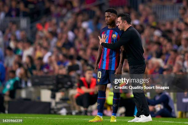 Xavi Hernandez, head coach of FC Barcelona gives instructions to his player Ansu Fati during the LaLiga Santander match between FC Barcelona and...