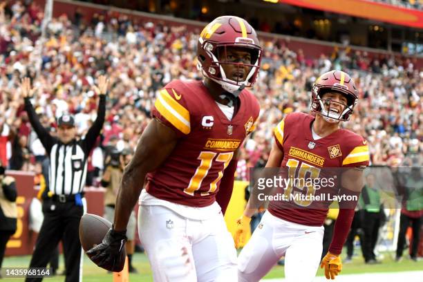 Terry McLaurin of the Washington Commanders and Dax Milne celebrate after a touchdown during the third quarter of the game against the Green Bay...
