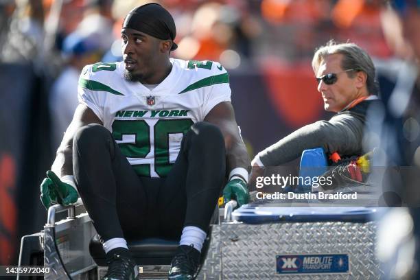 Breece Hall of the New York Jets is carted off the field after an apparent injury following a play against the Denver Broncos during the first half...