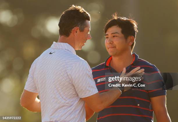 Kurt Kitayama of The United States congratulates Rory McIlroy of Northern Ireland on the 18th green after McIlroy won during the final round of the...