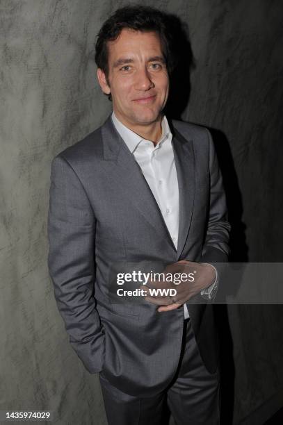 Clive Owen attends The Cinema Society's premiere party for "Intruders" at Double Seven. Owen wears Giorgio Armani.