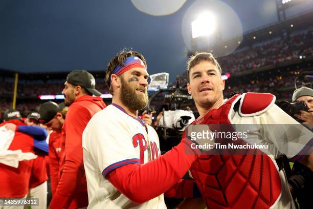 Bryce Harper of the Philadelphia Phillies celebrates with J.T. Realmuto after defeating the San Diego Padres in game five to win the National League...