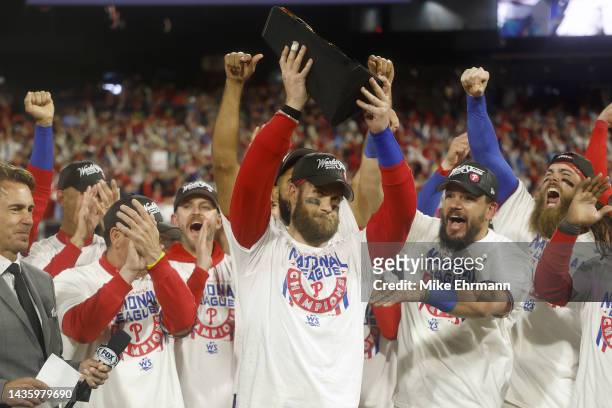 Bryce Harper of the Philadelphia Phillies lifts the National League Championship Series MVP trophy after the Phillies defeated the San Diego Padres...