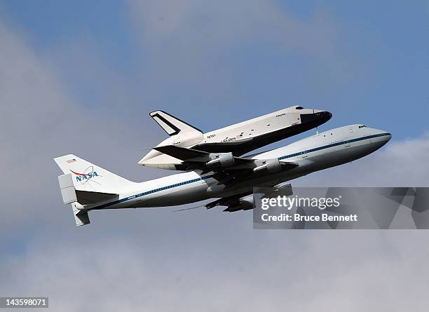 Riding atop a 747 shuttle carrier aircraft, the space shuttle Enterprise flies over New York Harbor on April 27, 2012 in New York City. Enterprise,...