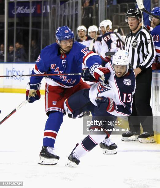 Johnny Gaudreau of the Columbus Blue Jackets is checked by Ryan Lindgren of the New York Rangers during the second period at Madison Square Garden on...