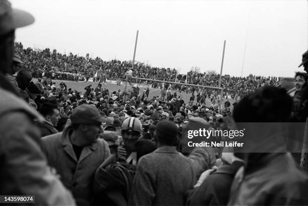 Championship: Overal view of Green Bay Packers fans victorious, hanging from goal posts after winning game vs New York Giants at City Stadium. Green...