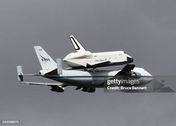 Riding atop a 747 shuttle carrier aircraft, the space shuttle Enterprise flies over New York Harbor on April 27, 2012 in New York City. Enterprise,...