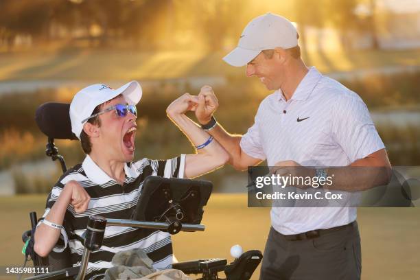 Rory McIlroy of Northern Ireland celebrates with Kyler Aubrey, of Statesboro, Ga. After winning during the final round of the CJ Cup at Congaree Golf...