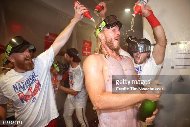 Noah Syndergaard of the Philadelphia Phillies celebrates with his teammates in the locker room after defeating the San Diego Padres in game five to...