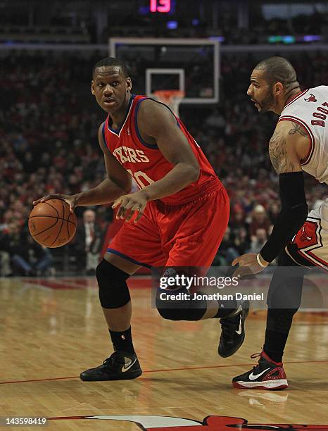 Lavoy Allen of the Philadelphia 76ers moves around Carlos Boozer of the Chicago Bulls in Game One of the Eastern Conference Quarterfinals during the...
