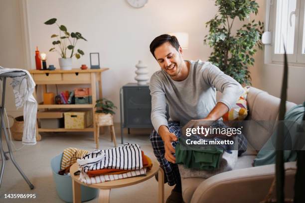 cleaning day always end with packing away the washing - folding stock pictures, royalty-free photos & images