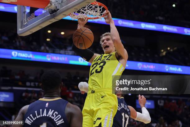 Lauri Markkanen of the Utah Jazz dunks as Zion Williamson of the New Orleans Pelicans and Jonas Valanciunas defend during the first half of a game at...