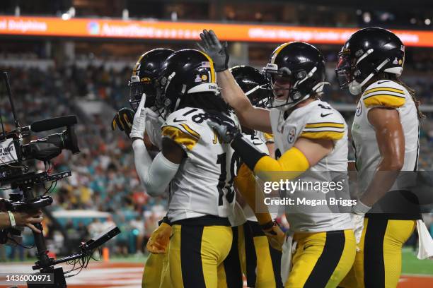 George Pickens of the Pittsburgh Steelers celebrates with teammates after scoring a touchdown during the second quarter against the Miami Dolphins at...