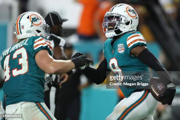 Noah Igbinoghene of the Miami Dolphins celebrates with Andrew Van Ginkel after intercepting a pass by Kenny Pickett of the Pittsburgh Steelers during...