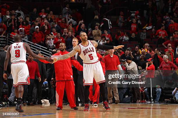 Carlos Boozer and Luol Deng of the Chicago Bulls high five each other against the Philadelphia 76ers in Game One of the Eastern Conference...