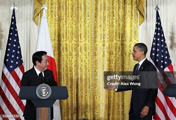 President Barack Obama extends his hand for a handshake with Japanese Prime Minister Yoshihiko Noda during a press conference at the East Room of the...